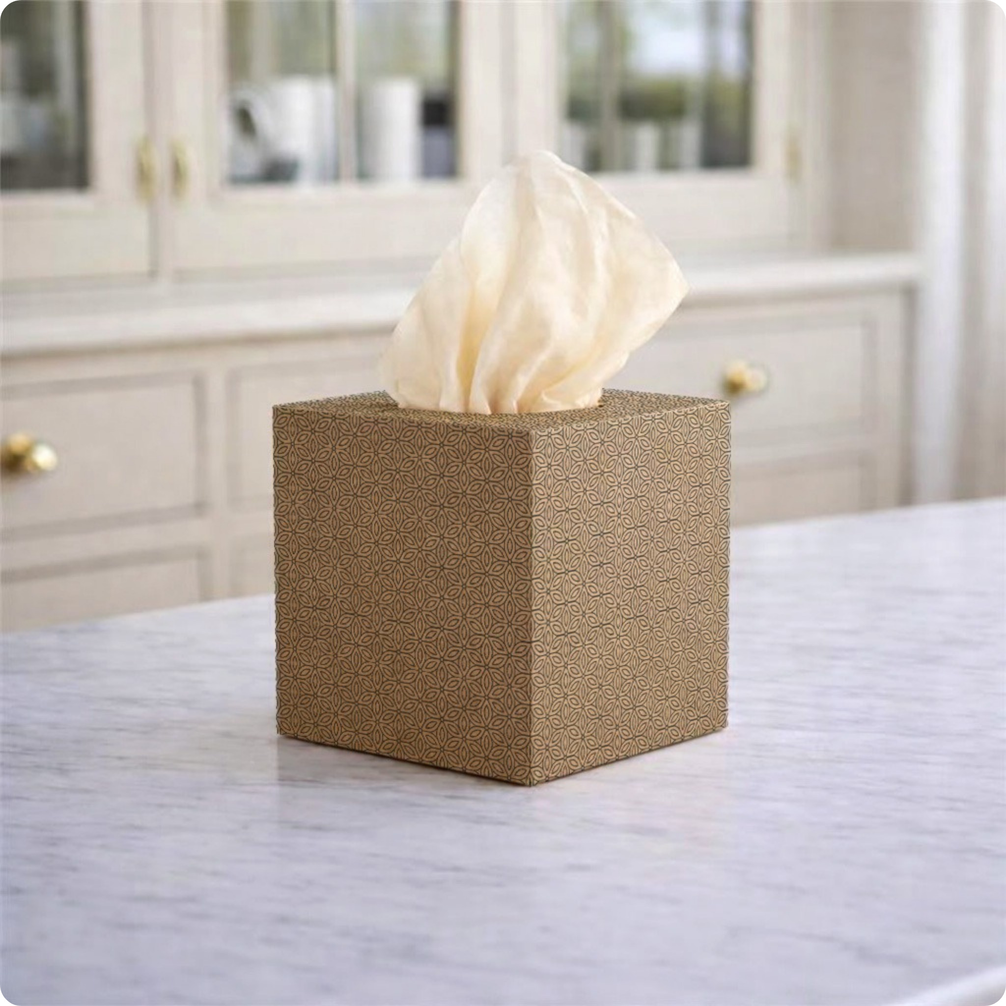 Square tissue box on a marble countertop with a blurred kitchen background