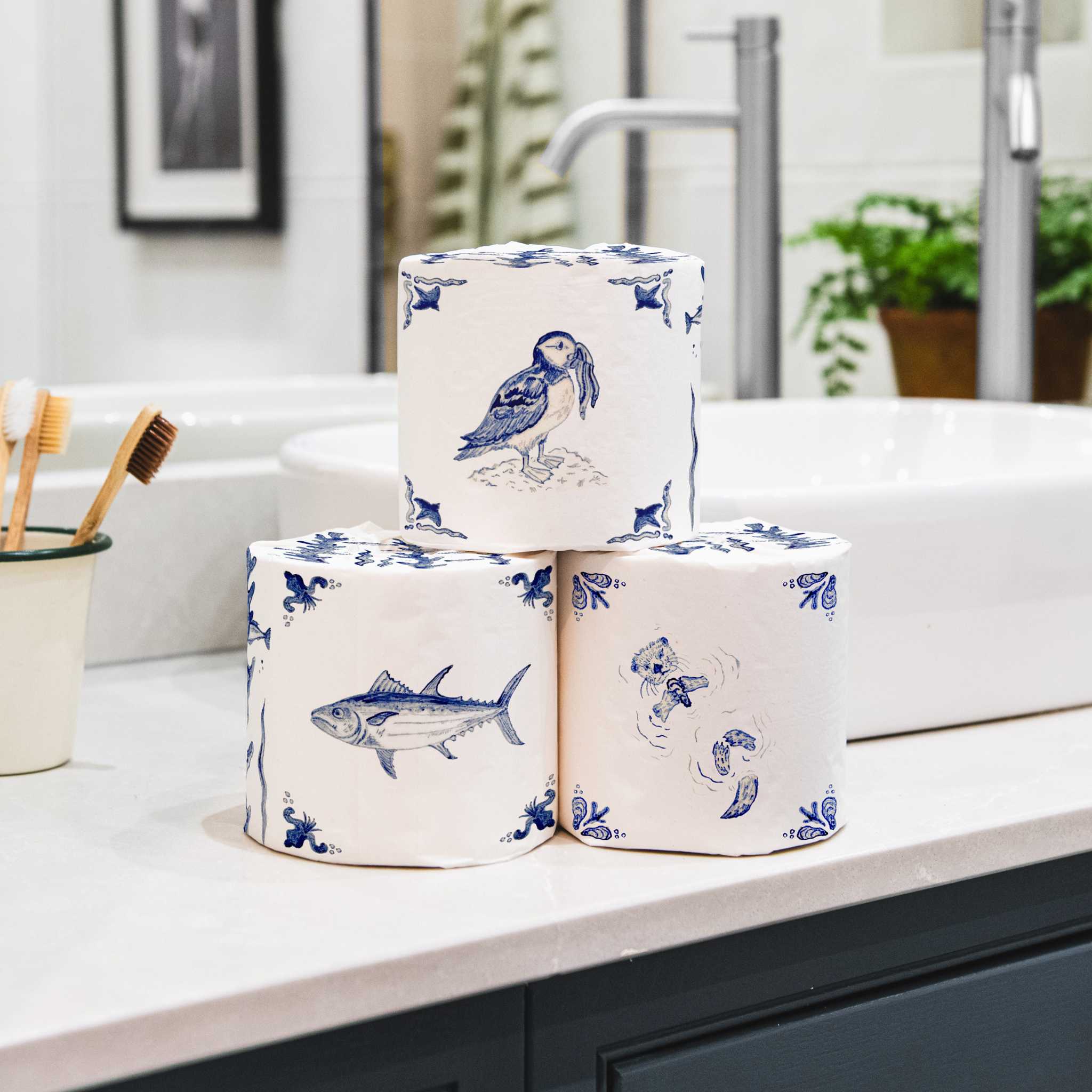 Stack of bamboo toilet paper wrapped in an english delft design in bathroom