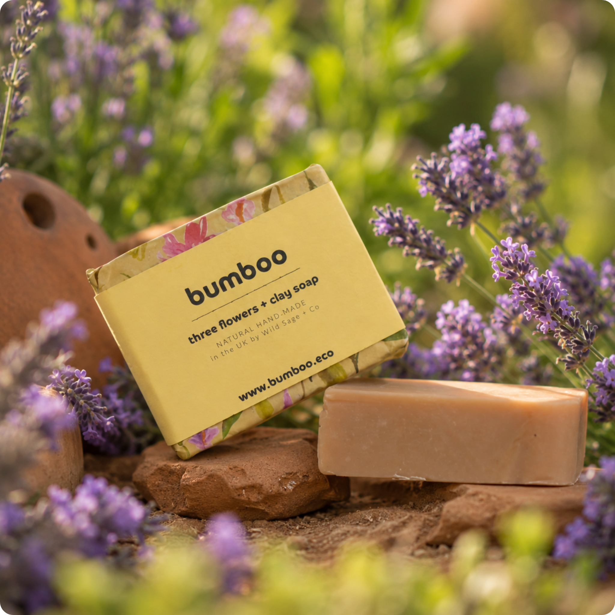 Bumboo soap bar with packaging in a natural setting with lavender flowers