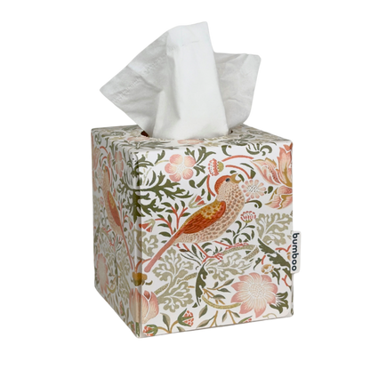A square tissue box cover with a white tissue protruding from the top, decorated with a classic William Morris floral and bird pattern in muted pink, green, and brown tones. A small side tag reads &
