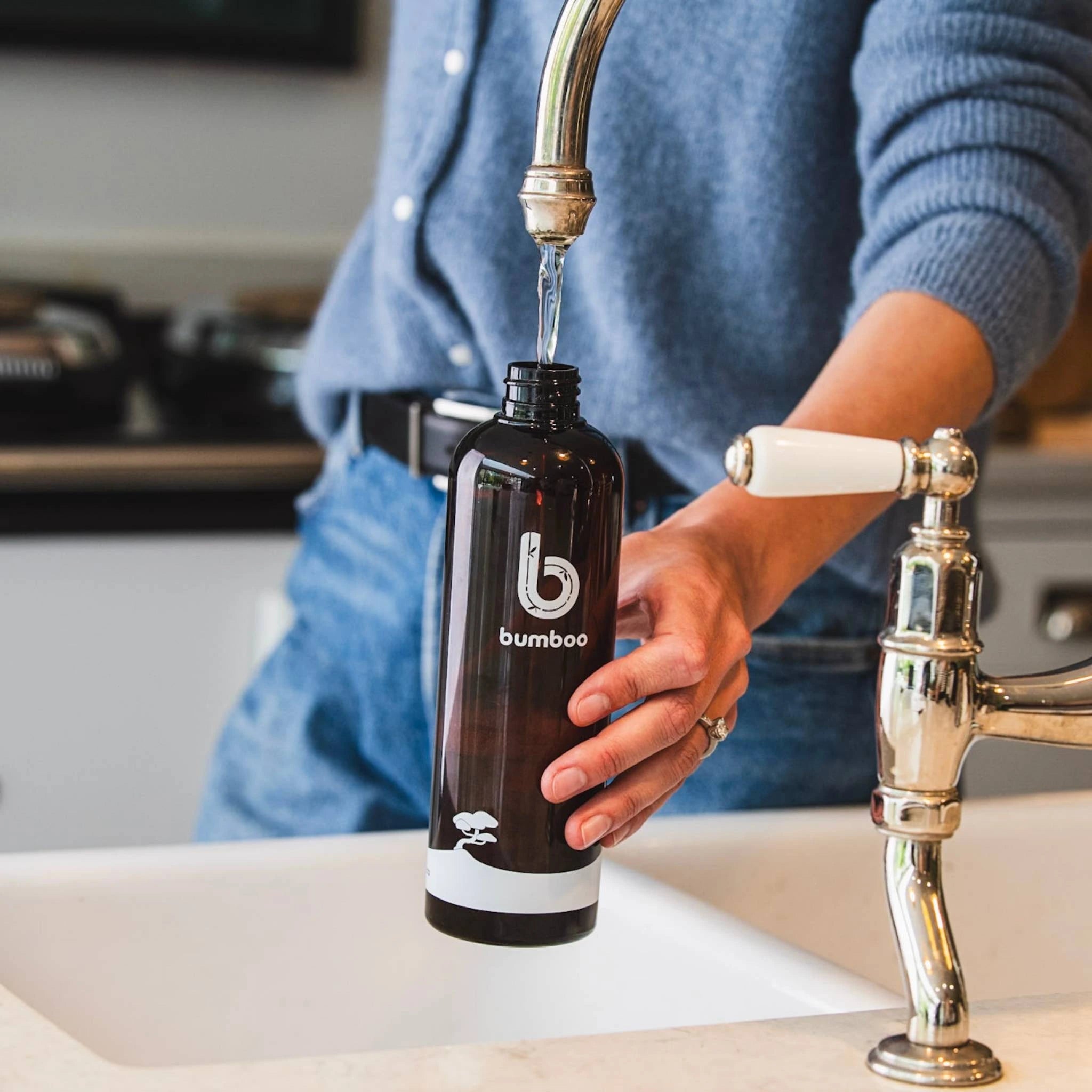 Adding water to bumboo cleaning bottle