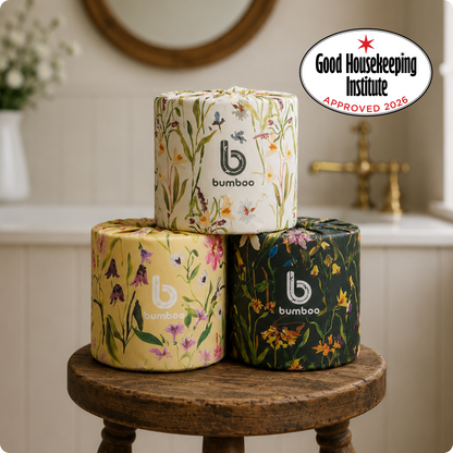 Three rolls of bamboo toilet paper with floral designs on a wooden stool, Good Housekeeping Institute logo visible.