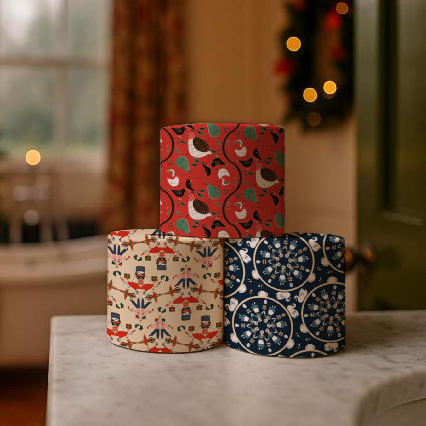 Stack of Christmas wrapped toilet rolls with a decorated tree in the background