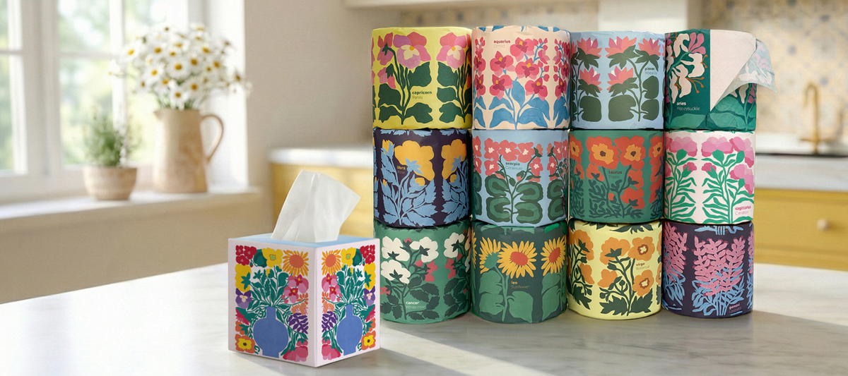 Stack of colorful patterned toilet paper rolls on a kitchen counter.
