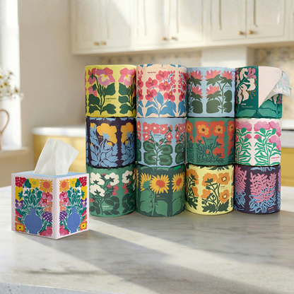 Stack of floral-patterned toilet paper rolls on a kitchen counter.